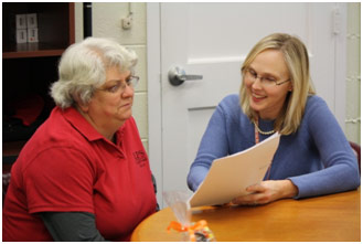 Two school administrators discussing a file