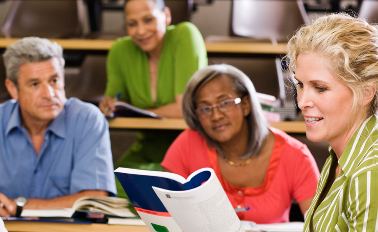 A group of adults in a classroom